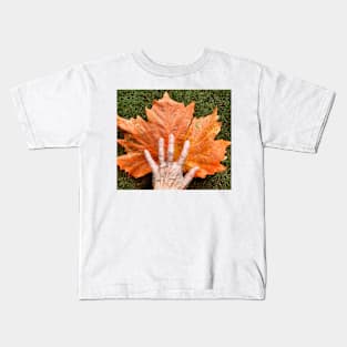 Autumn leaf and hand Kids T-Shirt